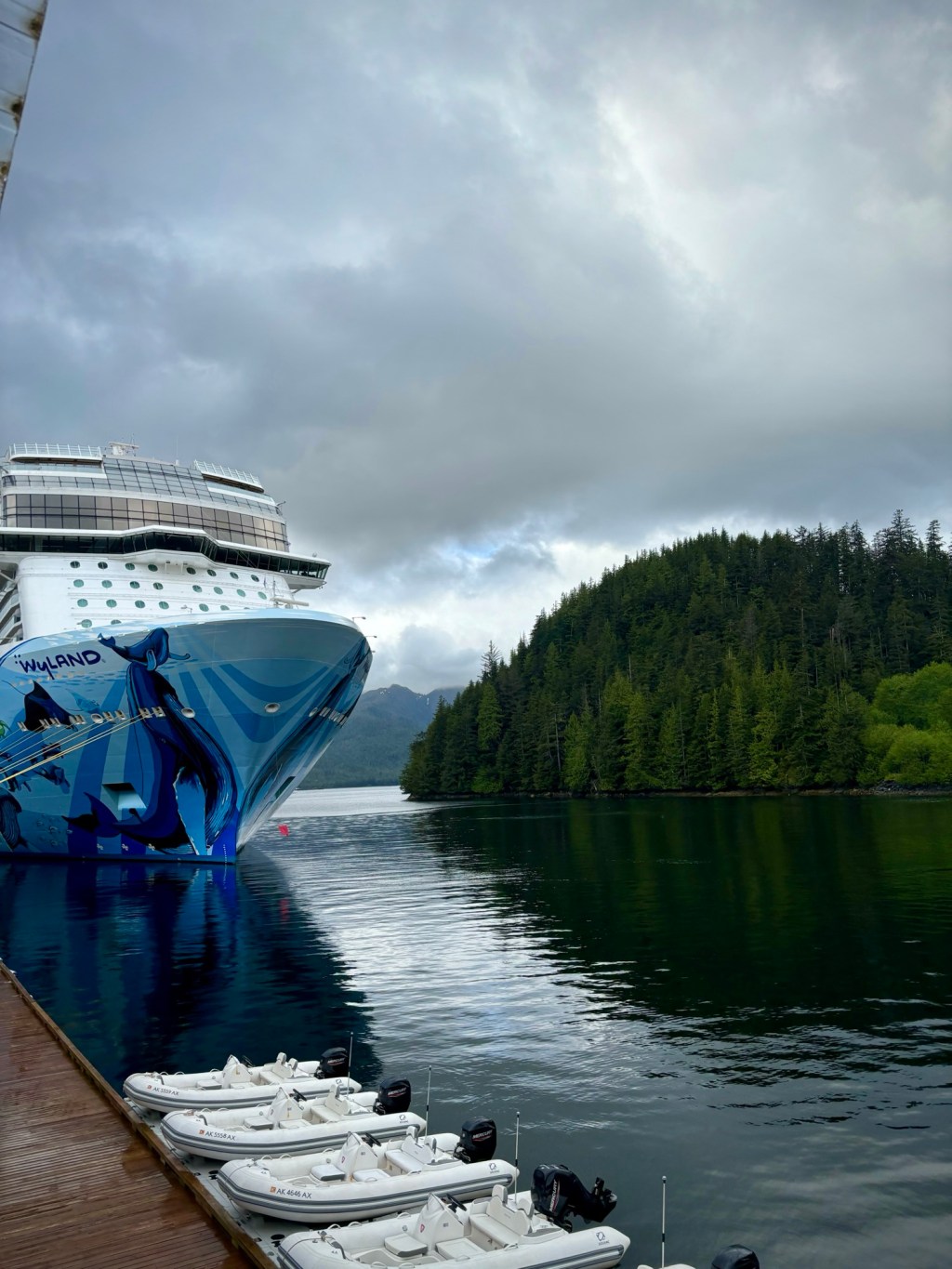 Norwegian Bliss Cruise ship with Alaskan forests in the background