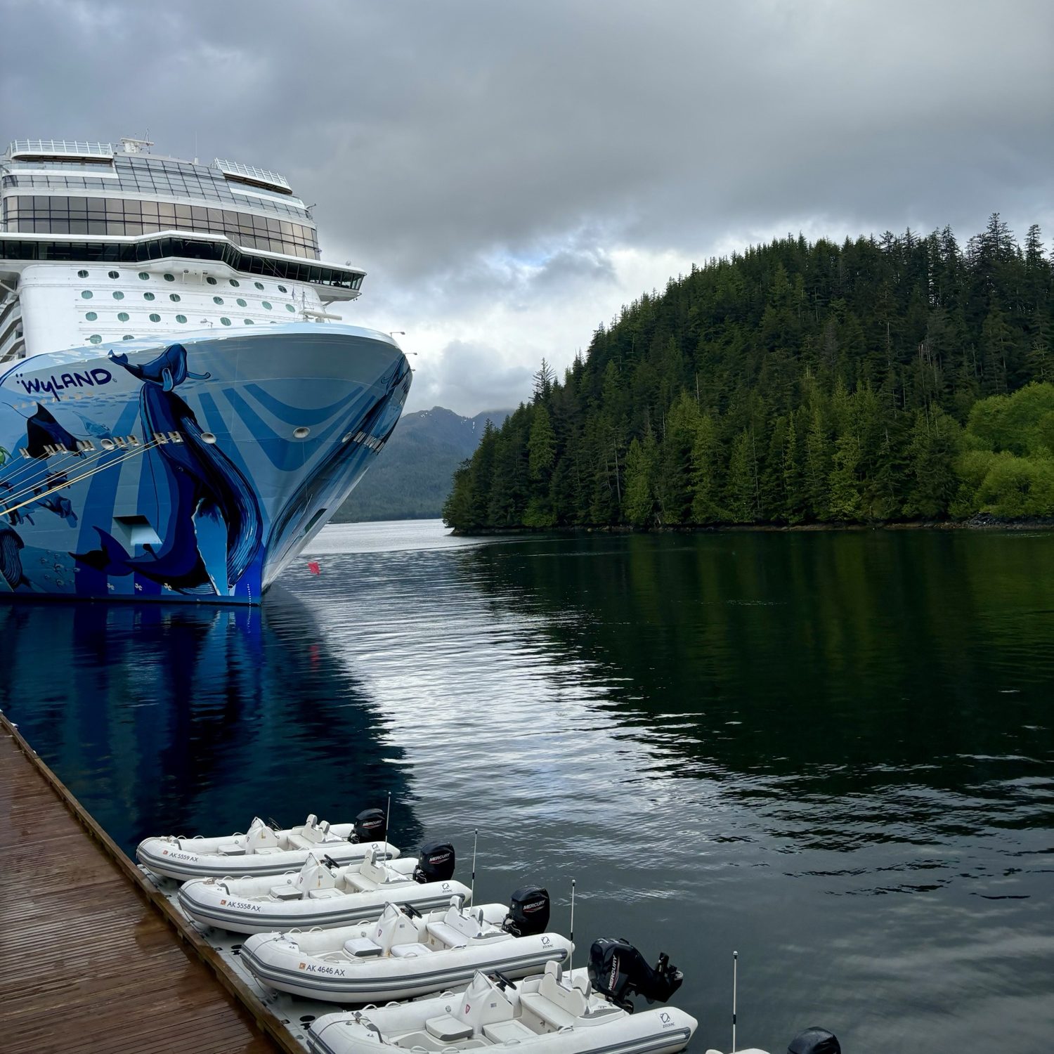 Norwegian Bliss Cruise ship with Alaskan forests in the background
